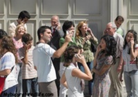 group of happy people on cellphones